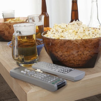 Popcorn, beer, and remote controls on coffee table