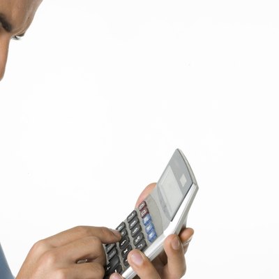 Businessman using calculator