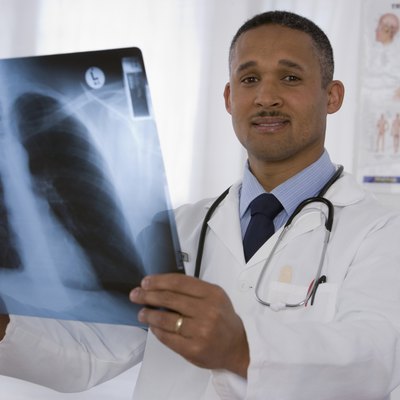 African doctor holding x-ray