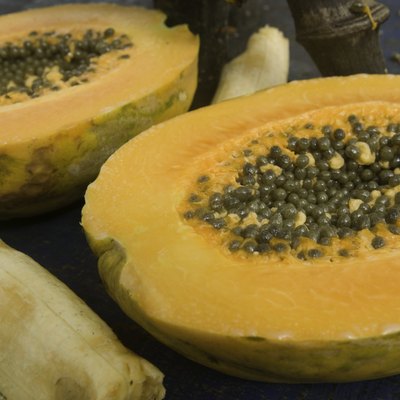 Exotic papaya fruit with seeds and banana, close-up