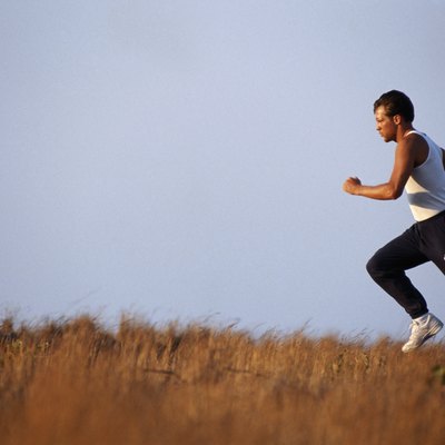 Mid adult man running, side view