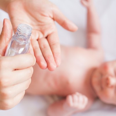 Mother makes massage for happy baby