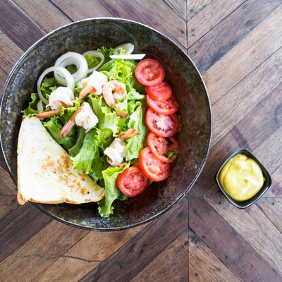 Top view of fresh salad vegetable and shrimp on bowl with castard