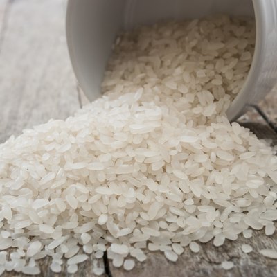 rice in cup on wooden background