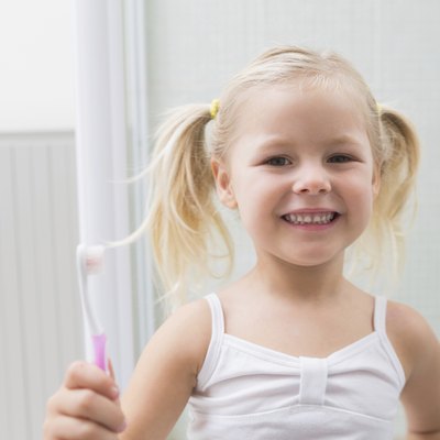 Cute girl brushing her teeth