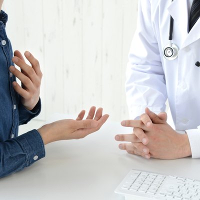 Patient's hand while explaining for doctor