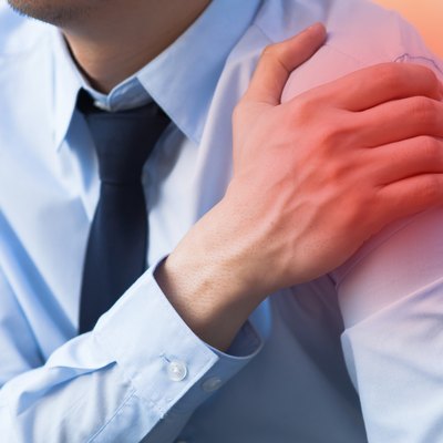 Man having shoulder pain problem with red spot