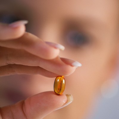 Close-up of woman's hand holding capsule