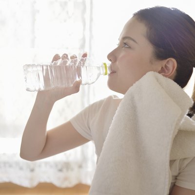 Woman drinking water in the room