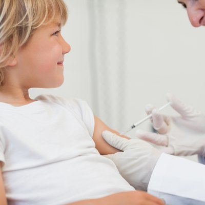 Doctor giving to a child an injection