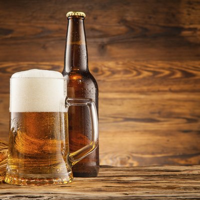 Glass and bottle of beer on wooden planks
