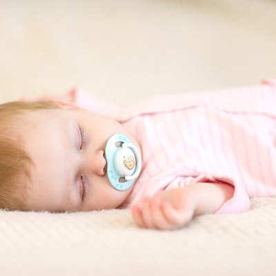 Baby girl sleeping on the bed