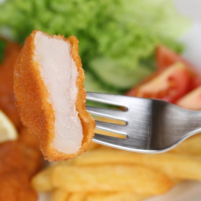 Eating Schnitzel chop meal with fork