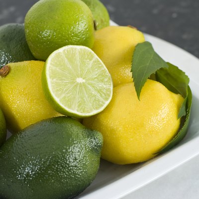 Bowl Of Fresh Lemon & Limes On Kitchen Table