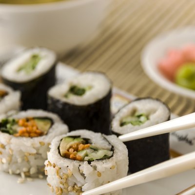Picking up vegetable sushi with chopsticks