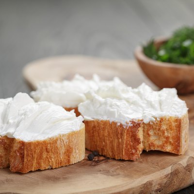 homemade appetizing crostini with soft cheese cream herbs