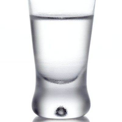 Glass of vodka isolated on white