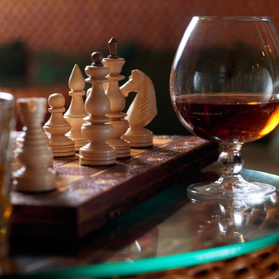 Chess-board and a glass of wine