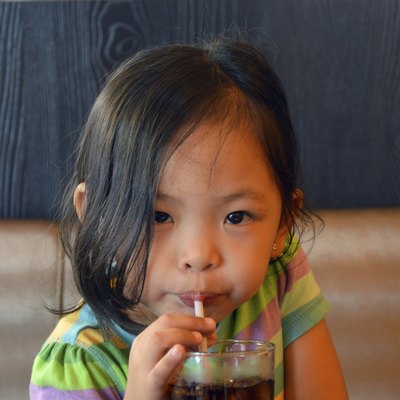 child sipping soda