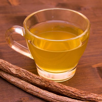 Herbal tea licorice inside cup on wood