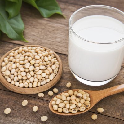 Soy milk and soy bean on wooden background