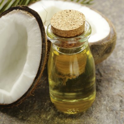 coconut oil in a glass bottle and fresh nuts