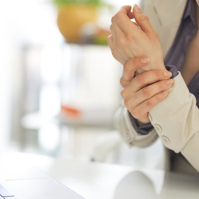 closeup on business woman with wrist pain