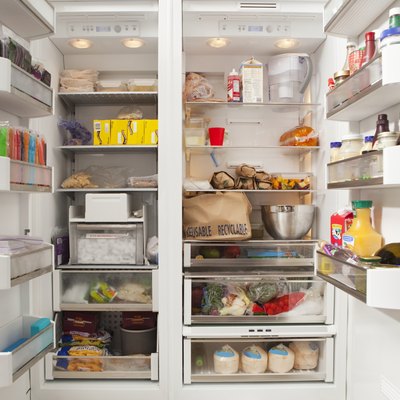 Stacked products in open fridge