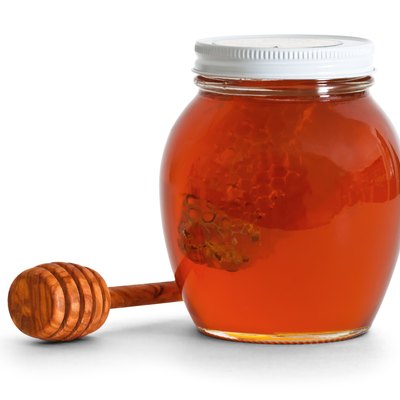 jar of honey with dipper