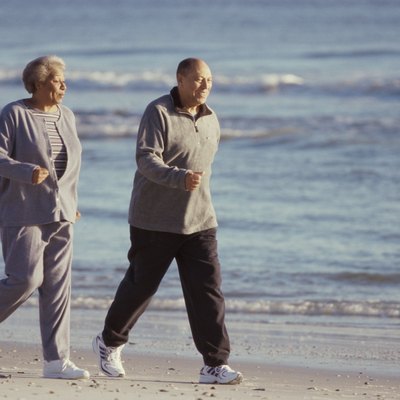Senior couple walking at the beach