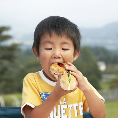 Japanese boy eating a sandwich