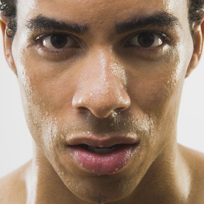 Close up of Mixed Race man's wet face
