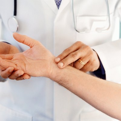 doctor checking a patients pulse