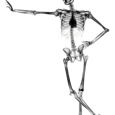 Leaning skeleton against white