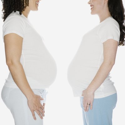 Multi-ethnic pregnant women facing each other