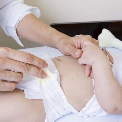Mother with baby on changing table
