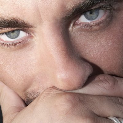Close up of Hispanic man with hand on face