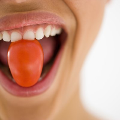 Woman eating a tomato