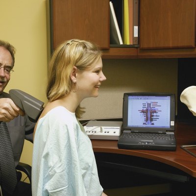 Doctor examining patients back