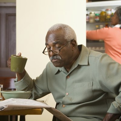 Senior African man reading newspaper