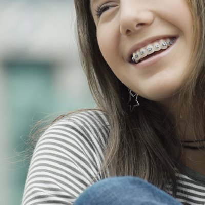 Close-up of a teenage girl smiling with braces