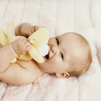 Portrait of a Baby Lying on a Bed