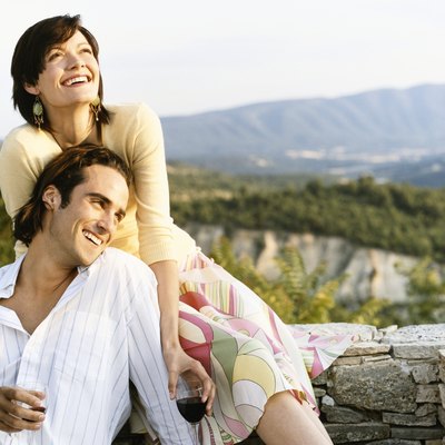 Young Couple havinf Fun and Drinking Red Wine