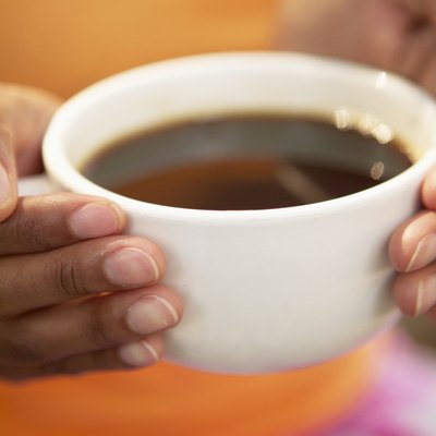 Hands holding cup of coffee