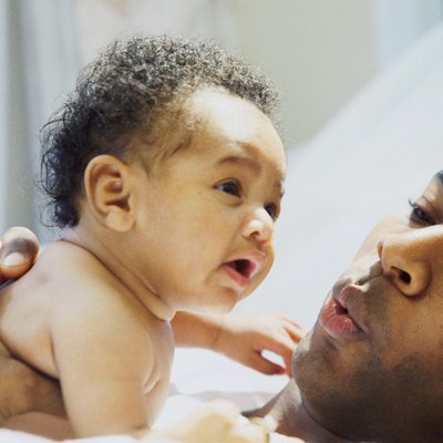 Close-up of a father consoling his daughter