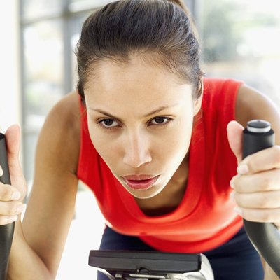 Close-up of a young woman exercising on an exercise bicycle