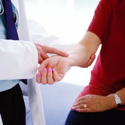 doctor checking the pulse of a patient