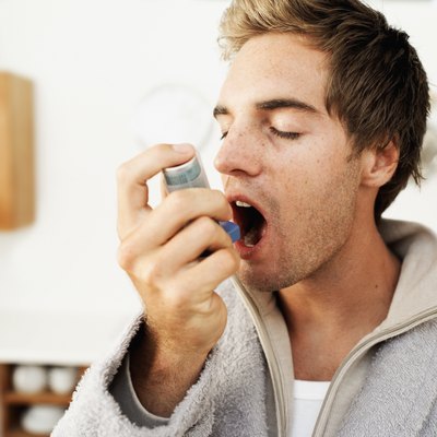 Close-up of a man using an inhaler