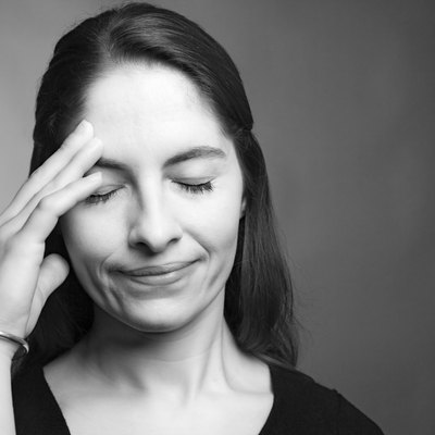Woman with hand on head