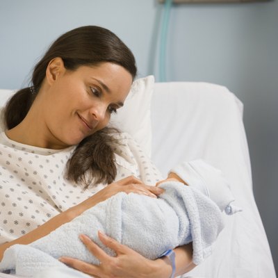 Hispanic woman in hospital with newborn baby